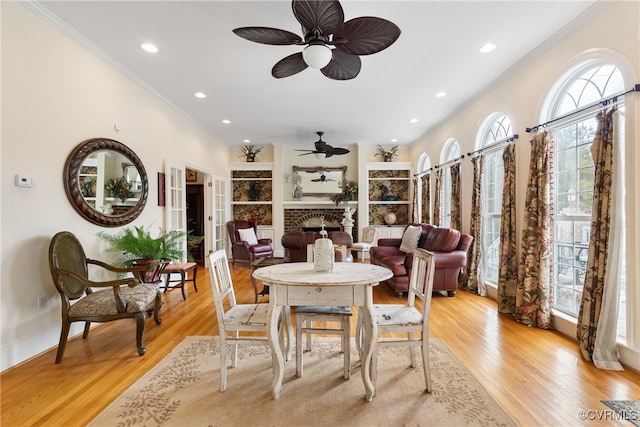 dining area featuring ceiling fan, light hardwood / wood-style flooring, and ornamental molding