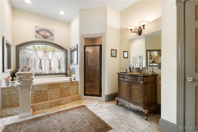 bathroom with shower with separate bathtub and vanity