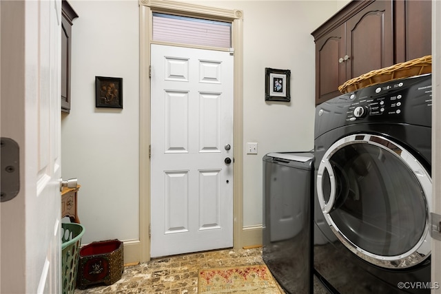 laundry area featuring cabinets and washing machine and clothes dryer