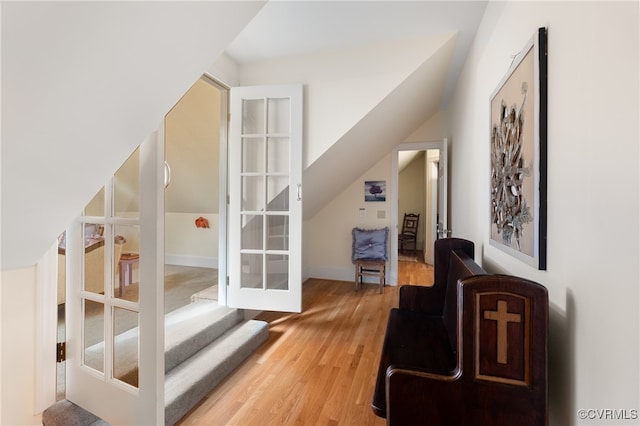 interior space featuring wood-type flooring and vaulted ceiling