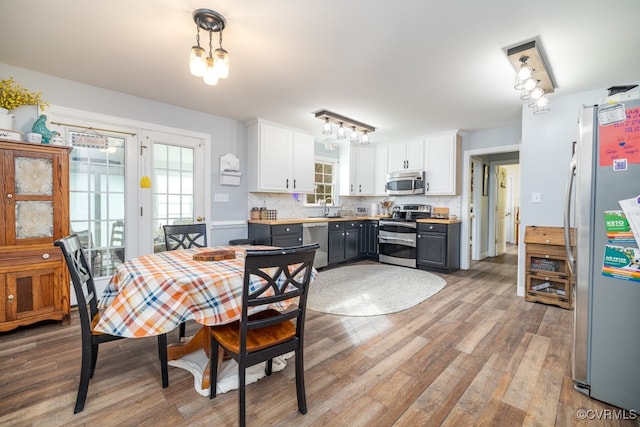 dining space featuring light wood-type flooring and sink