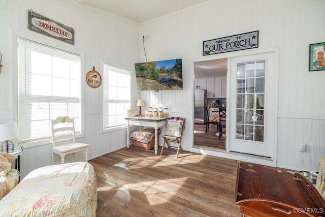 interior space featuring wood walls, dark wood-type flooring, and crown molding