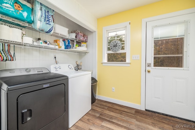 laundry room with hardwood / wood-style flooring and independent washer and dryer