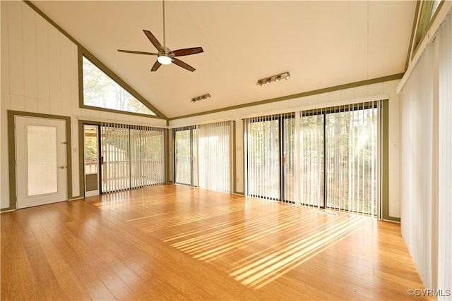 interior space with light hardwood / wood-style floors, ceiling fan, and high vaulted ceiling