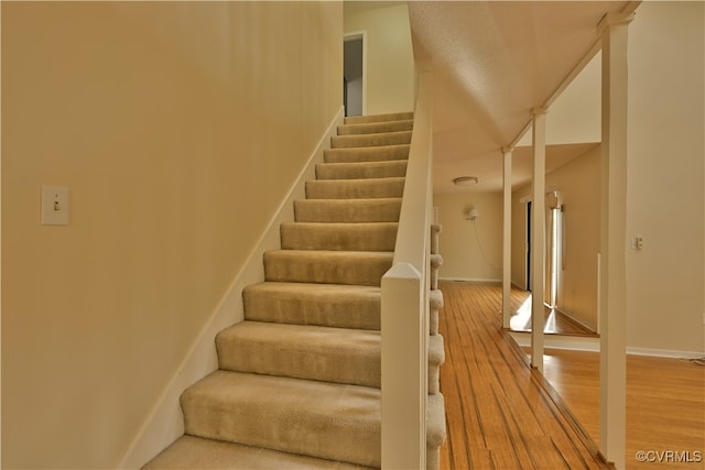 staircase featuring wood-type flooring