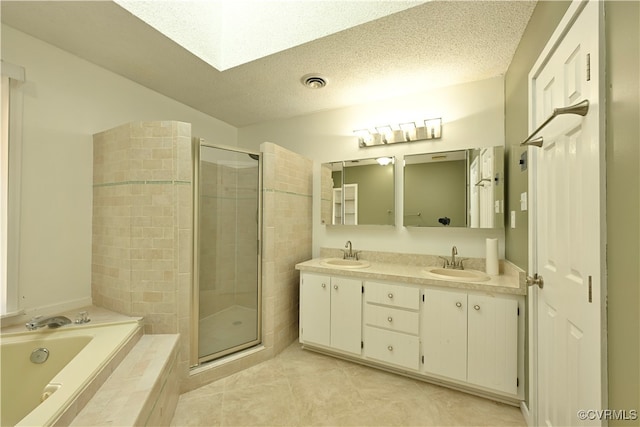 bathroom with shower with separate bathtub, vanity, a textured ceiling, and tile patterned floors