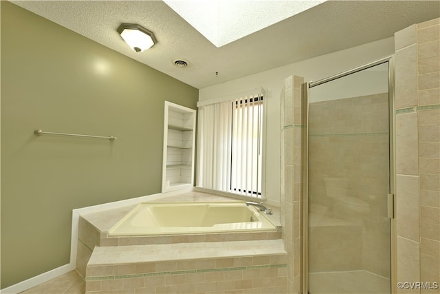 bathroom featuring tile patterned flooring, a textured ceiling, a skylight, and independent shower and bath