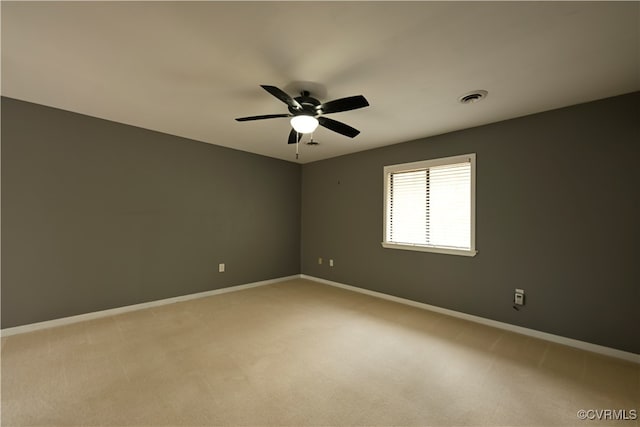 carpeted spare room featuring ceiling fan