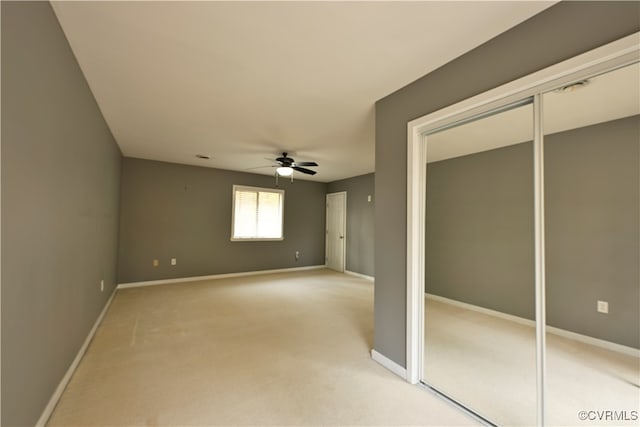 unfurnished bedroom with ceiling fan and light colored carpet