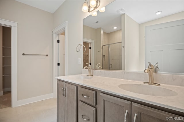 bathroom with vanity, a shower with door, and tile patterned flooring