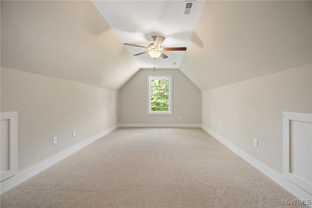 bonus room with light carpet, ceiling fan, and vaulted ceiling