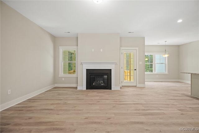 unfurnished living room with light hardwood / wood-style flooring