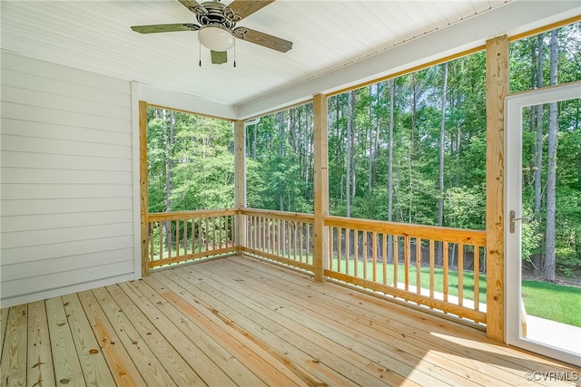 unfurnished sunroom with ceiling fan