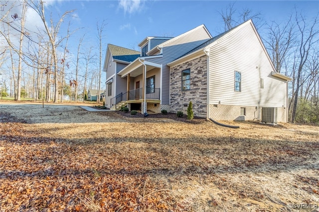 view of property exterior with covered porch and central AC unit