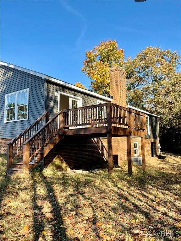 back of house featuring a wooden deck