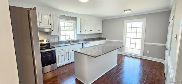 kitchen with dark wood-type flooring, sink, white cabinetry, a center island, and stainless steel appliances