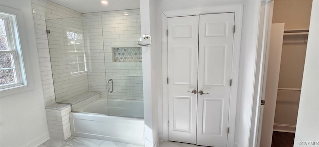 bathroom with shower / bath combination with glass door