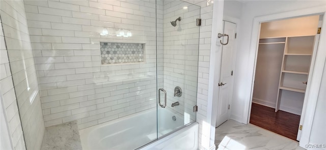 bathroom with shower / bath combination with glass door