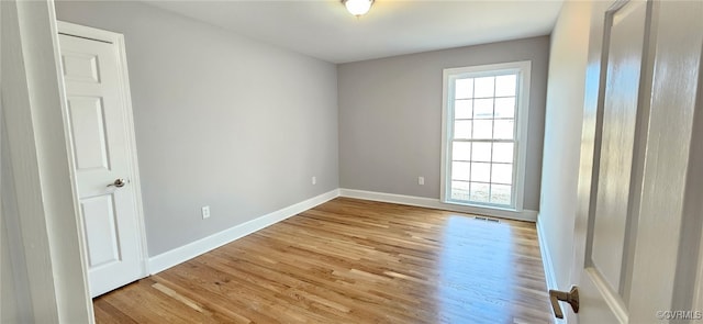 unfurnished room featuring plenty of natural light and light hardwood / wood-style floors