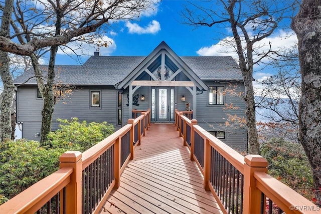 rear view of house featuring a wooden deck