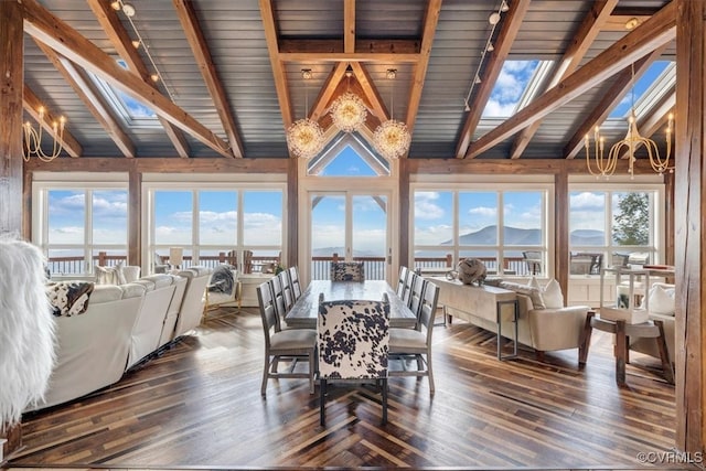 dining room featuring a wealth of natural light, a mountain view, dark hardwood / wood-style flooring, and high vaulted ceiling