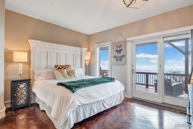 bedroom featuring access to exterior and dark tile patterned floors