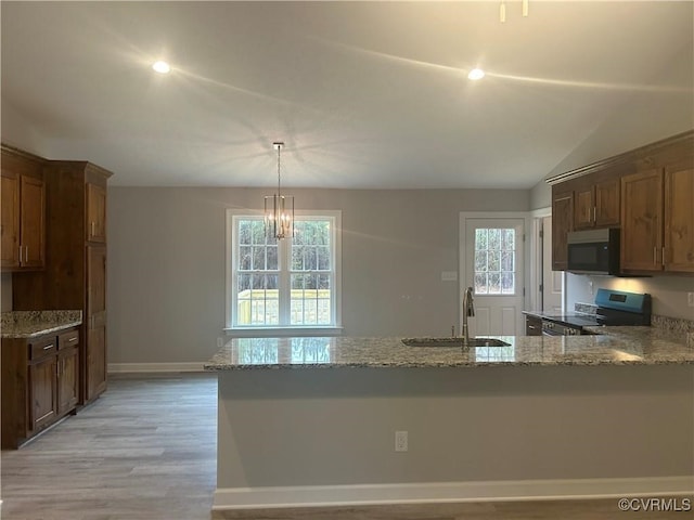 kitchen featuring plenty of natural light, light hardwood / wood-style flooring, sink, and stainless steel appliances