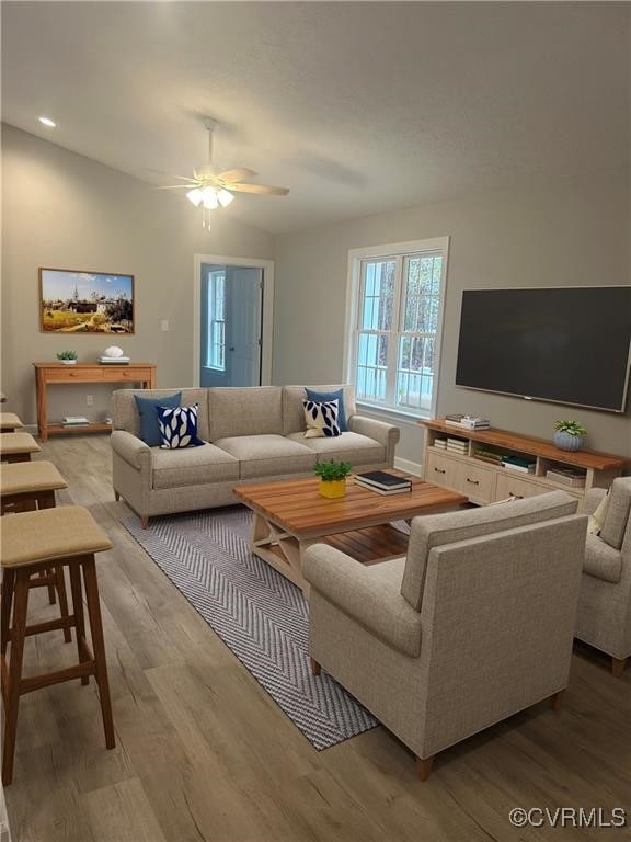 living room with light hardwood / wood-style floors and ceiling fan