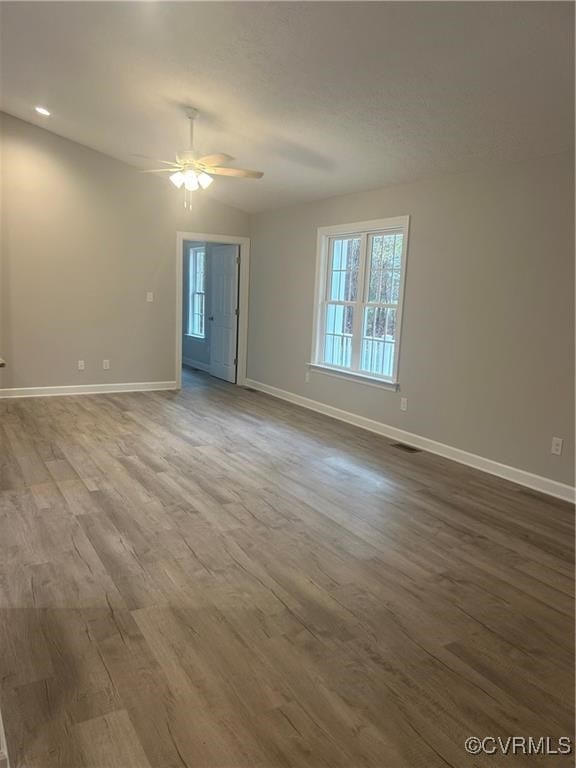 unfurnished room with hardwood / wood-style flooring and ceiling fan