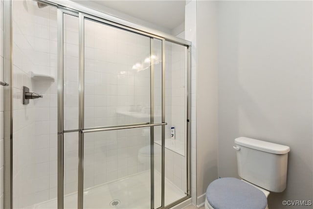 bathroom featuring an enclosed shower and toilet