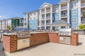 view of patio with grilling area and an outdoor kitchen