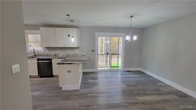 kitchen featuring black dishwasher, kitchen peninsula, white cabinets, hardwood / wood-style flooring, and decorative light fixtures