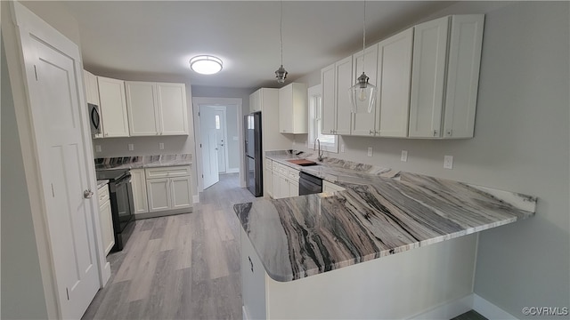 kitchen featuring white cabinetry, sink, black appliances, kitchen peninsula, and light wood-type flooring