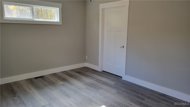 unfurnished room featuring hardwood / wood-style flooring