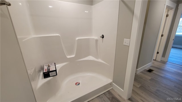 bathroom featuring hardwood / wood-style floors and a shower