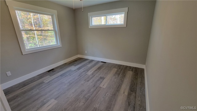 spare room with dark hardwood / wood-style floors