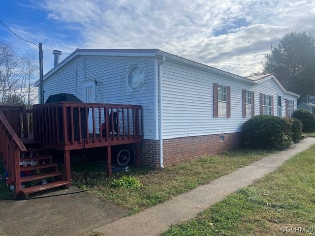 view of side of property with a wooden deck