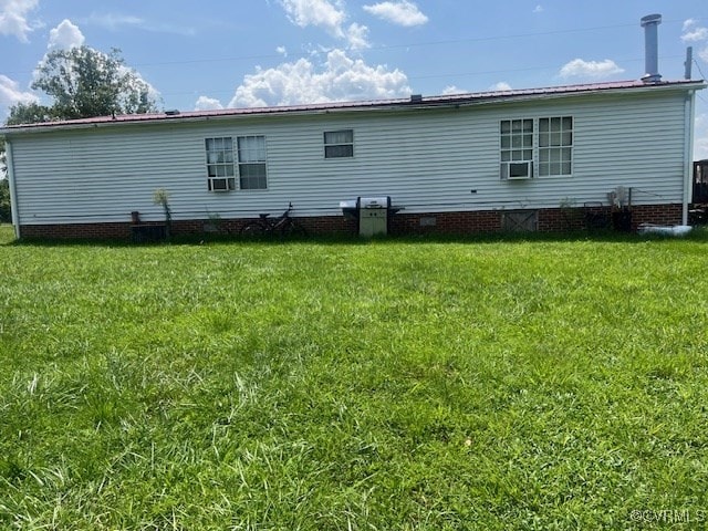 rear view of property with a yard