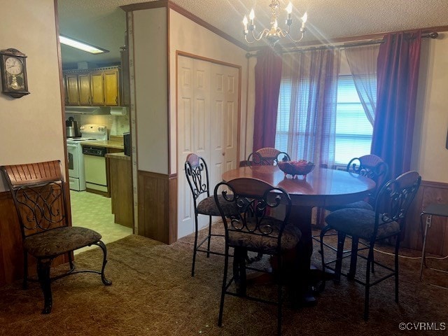 carpeted dining space with lofted ceiling, wooden walls, a textured ceiling, and a notable chandelier