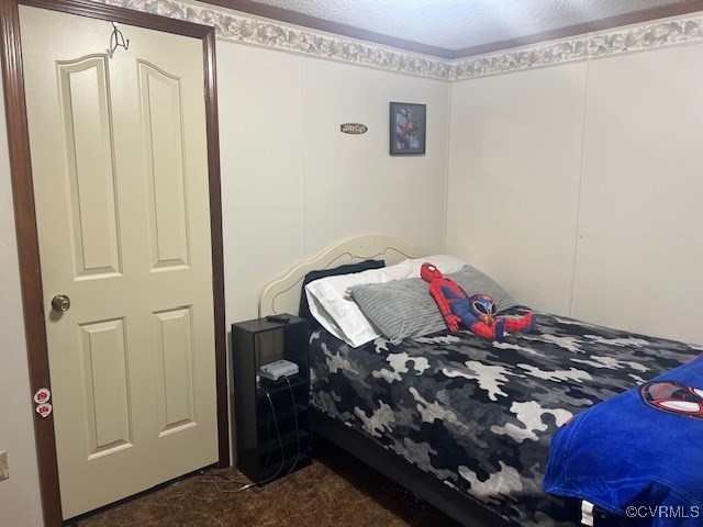 carpeted bedroom with a textured ceiling