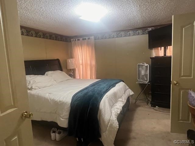 carpeted bedroom featuring a textured ceiling