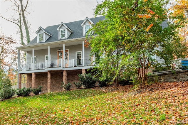 view of front of property with a porch and a front lawn