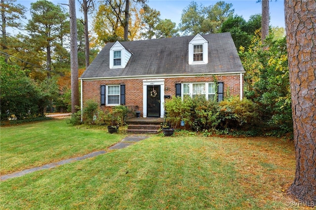 cape cod house with a front lawn