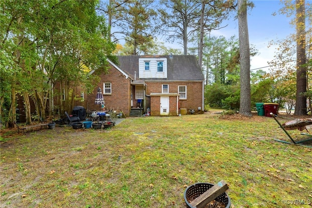 rear view of property with a yard