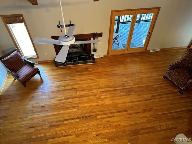 interior space featuring hardwood / wood-style floors and a tile fireplace