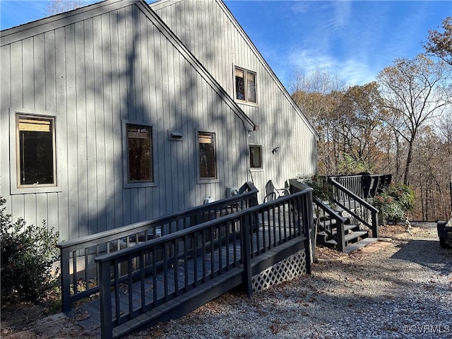 rear view of property featuring a wooden deck