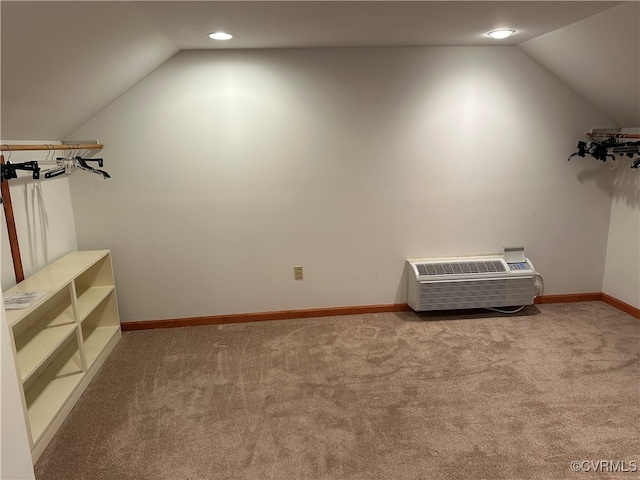 bonus room featuring a wall unit AC, lofted ceiling, and carpet floors