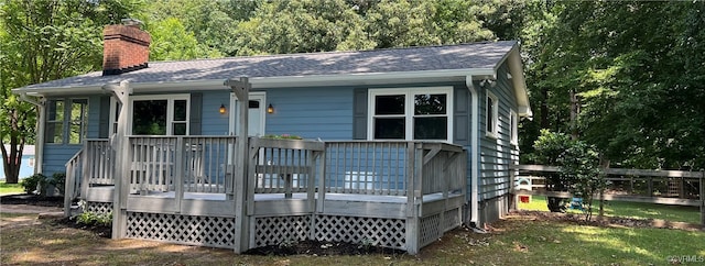 rear view of house featuring a wooden deck