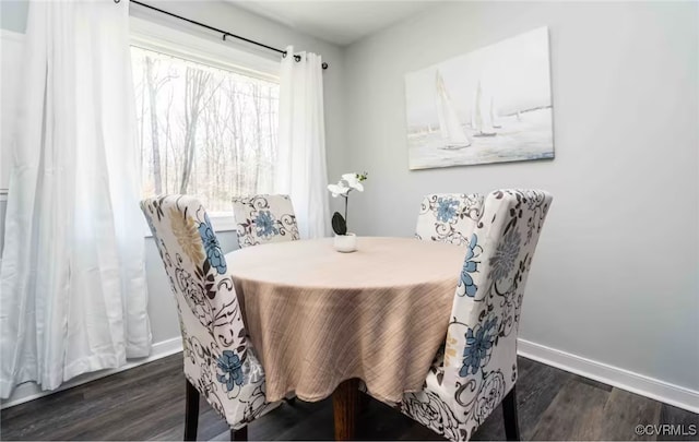 dining space with dark hardwood / wood-style flooring