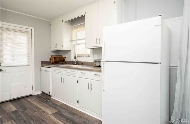 kitchen with ornamental molding, dark hardwood / wood-style flooring, sink, white cabinets, and white appliances